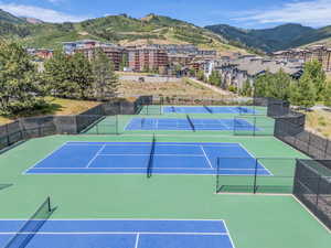 View of tennis court featuring community basketball court and a mountain view