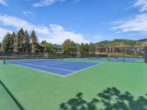 View of tennis court featuring a mountain view and community basketball court