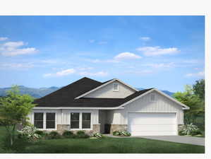 View of front facade with a front lawn, stone siding, board and batten siding, concrete driveway, and an attached garage