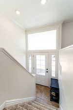 Foyer with tile patterned flooring, crown molding, recessed lighting, and baseboards