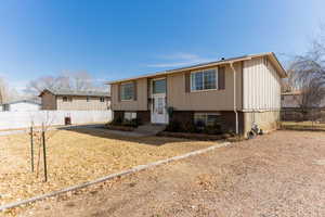 Split foyer home featuring brick siding and fence