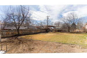 View of yard featuring fence