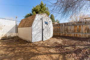 View of shed featuring a fenced backyard