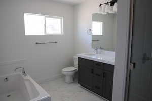 Full bath featuring baseboards, a sink, a garden tub, toilet, and marble finish floor