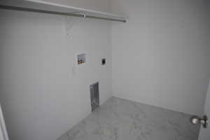 Washroom with baseboards, laundry area, hookup for a washing machine, marble finish floor, and hookup for an electric dryer