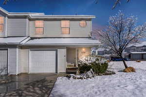 View of front of property featuring an attached garage and driveway