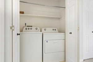 Washroom featuring washer and dryer and laundry area