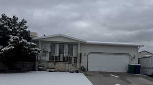 View of front of home featuring a garage and driveway