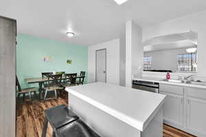 Kitchen featuring gray cabinets and light countertops