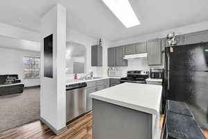 Kitchen featuring gray cabinets and light countertops