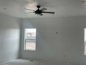 Unfurnished room with baseboards and ceiling fan