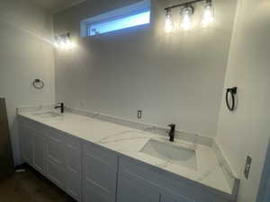 Full bathroom with double vanity and a sink