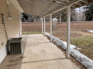 View of patio with central air condition unit and a fenced backyard