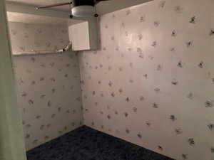 Carpeted empty room with wallpapered walls