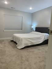 Carpeted bedroom featuring visible vents, recessed lighting, and baseboards
