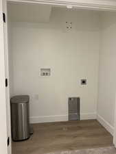 Laundry room featuring washer hookup, laundry area, wood finished floors, and baseboards