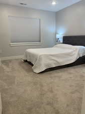 Bedroom featuring carpet, visible vents, and baseboards