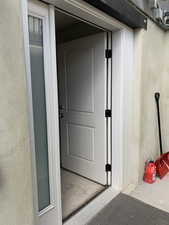 Property entrance featuring stucco siding