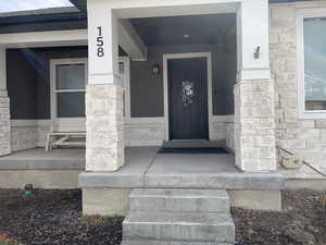 Doorway to property with stone siding