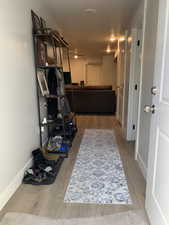 Hall featuring wood finished floors and baseboards