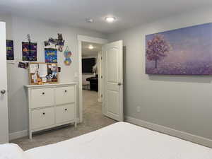 Carpeted bedroom with baseboards