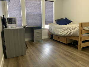 Bedroom featuring wood finished floors and baseboards