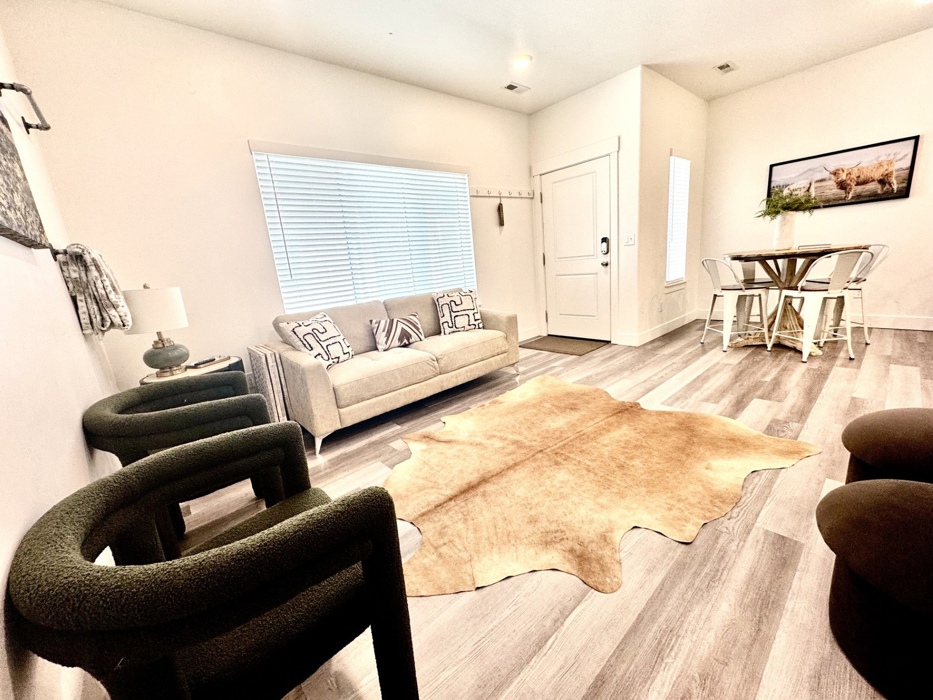 Open-concept living space featuring wood-finish flooring, recessed lighting