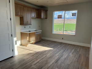 Kitchen featuring wood finished floors and baseboards