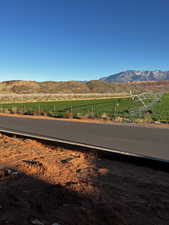 View of asphalt street featuring a mountain view and a view of countryside