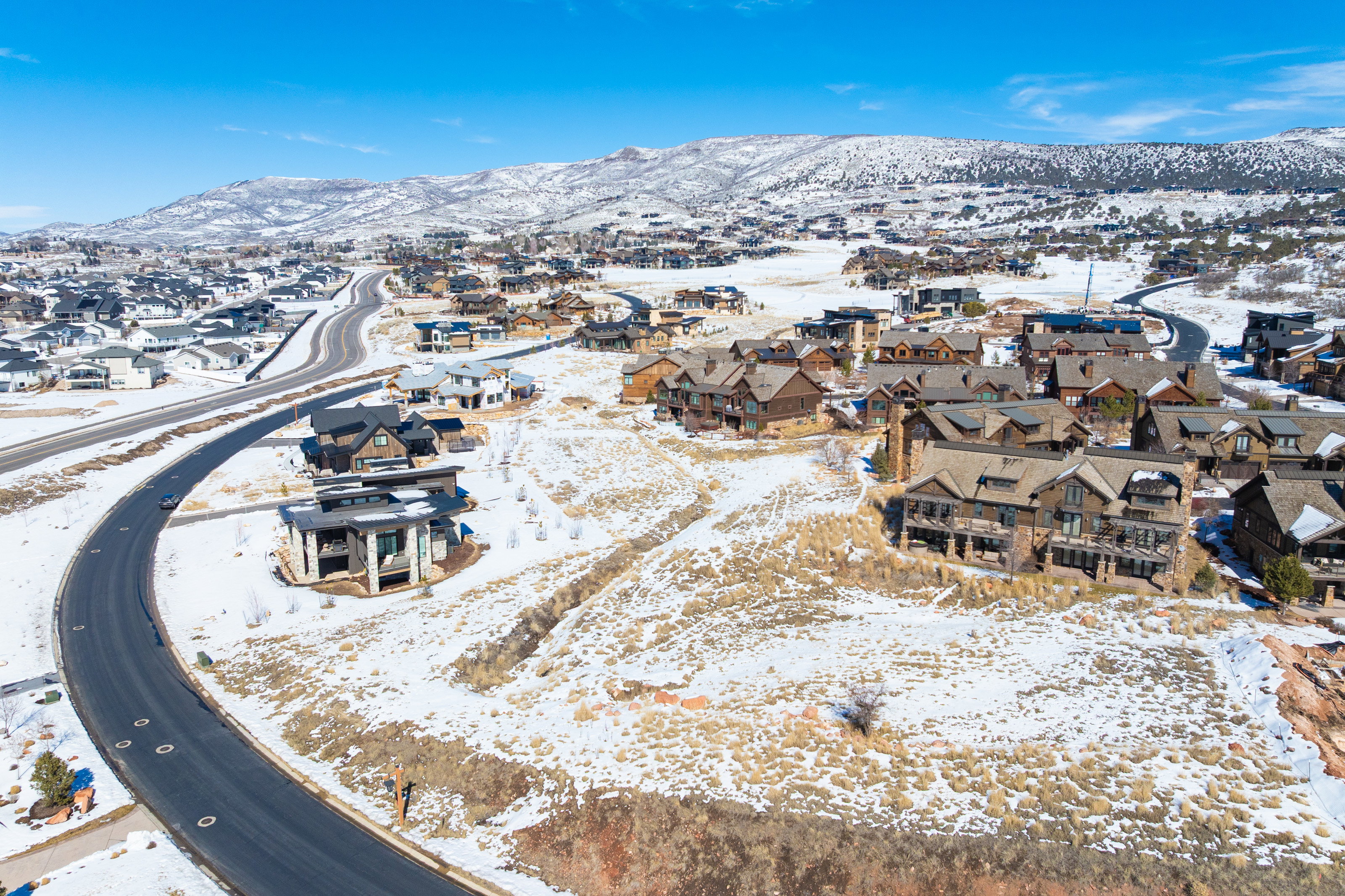 Snowy aerial view featuring a residential view and a mountain view