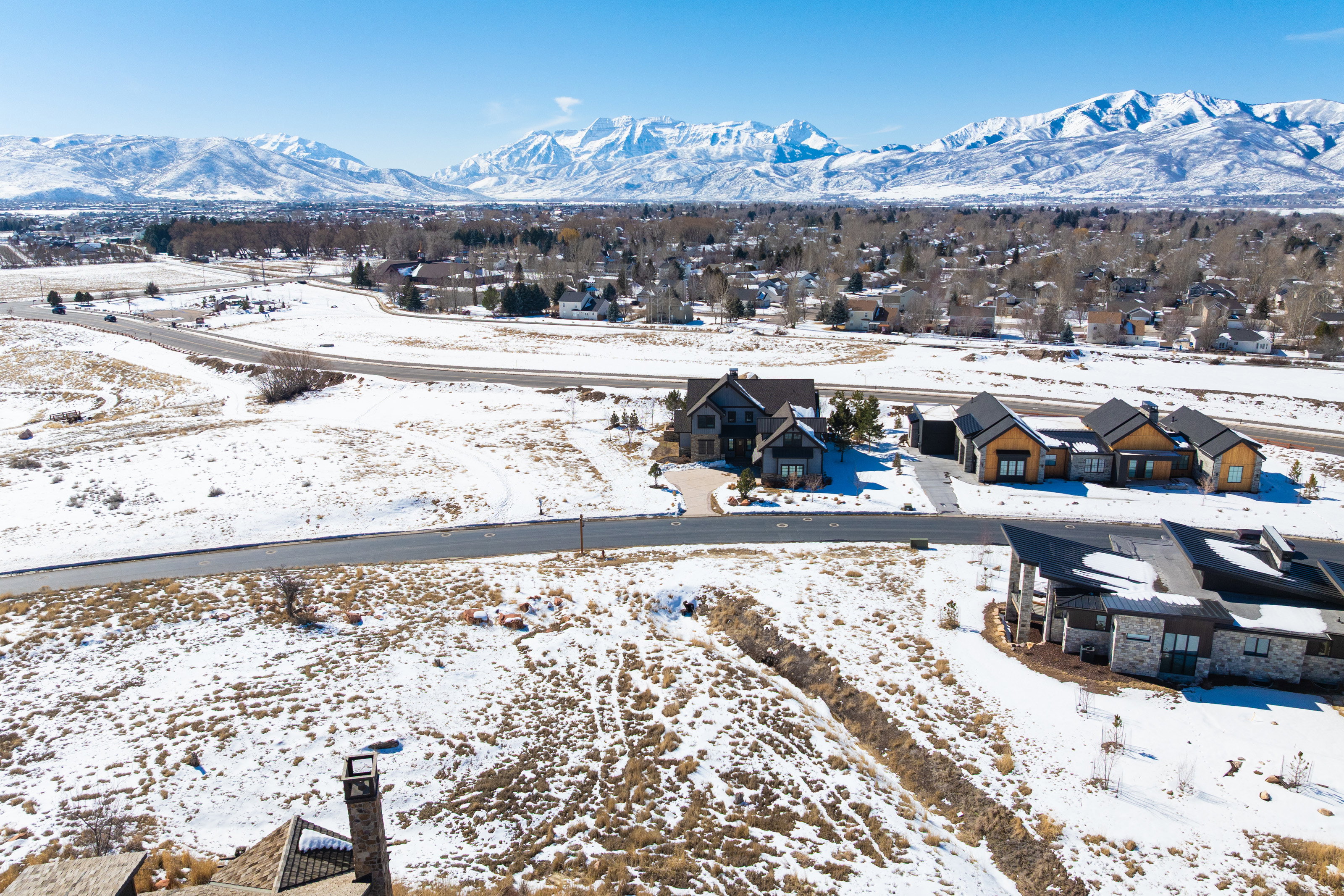 Snowy aerial view with a residential view and a mountain view