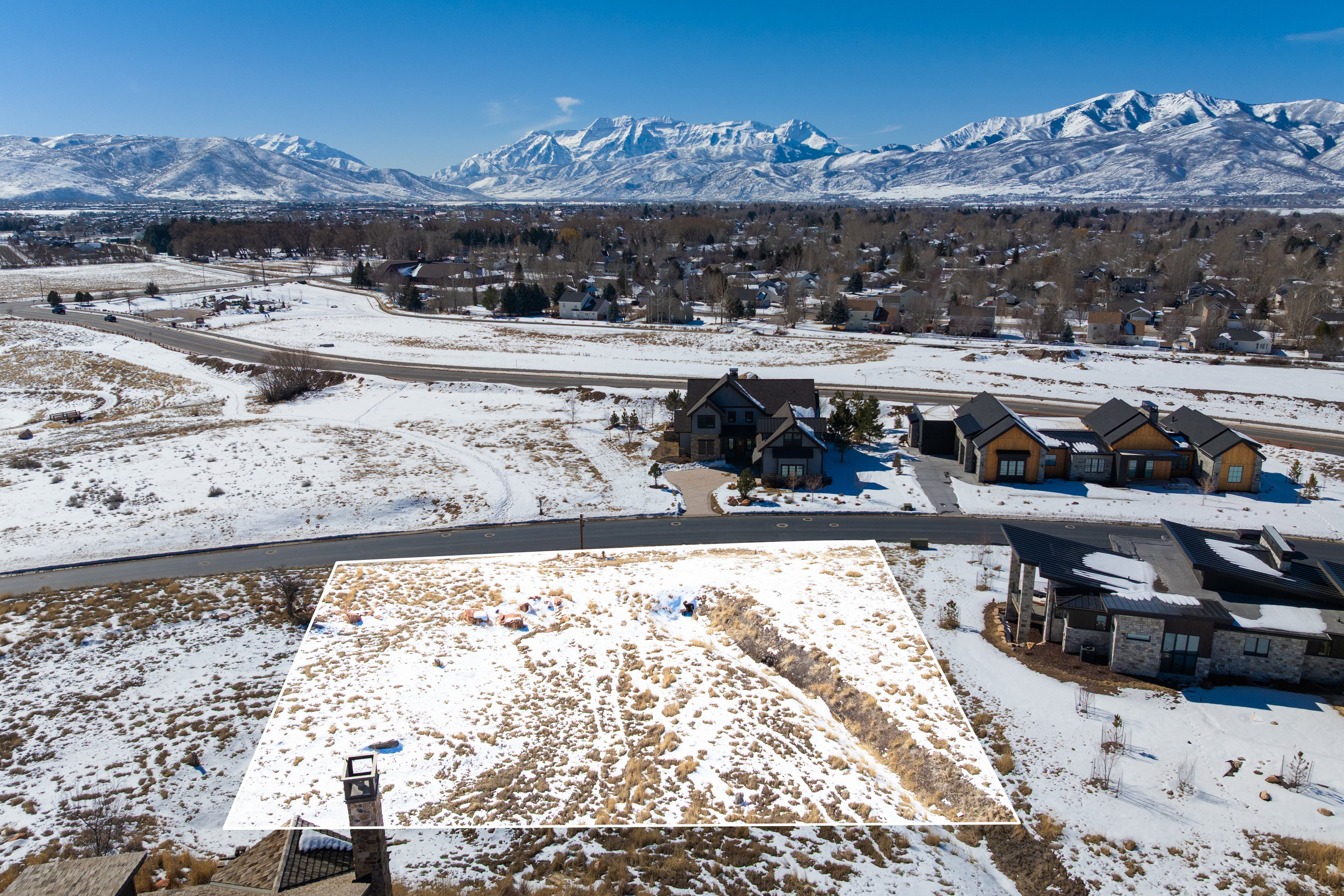 Snowy aerial view with a residential view and a mountain view