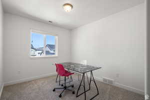 Carpeted office space with baseboards and visible vents