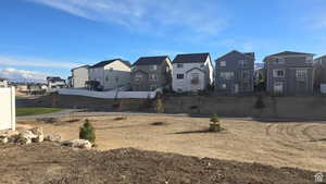 View of yard featuring a residential view and fence
