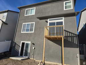 Rear view of house with stucco siding