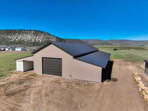 Detached garage with driveway and a mountain view