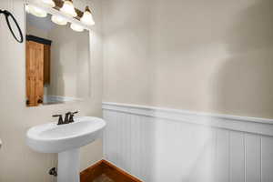 Bathroom with wainscoting and a sink