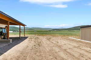 View of yard featuring a mountain view and a view of countryside