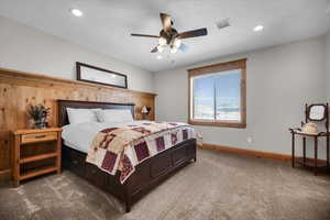 Bedroom with carpet floors, recessed lighting, a ceiling fan, and a textured ceiling