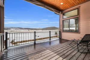 Snow covered deck with a mountain view