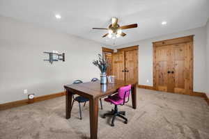 Office space featuring light carpet, a ceiling fan, and recessed lighting