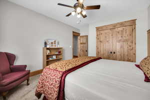 Bedroom featuring carpet and ceiling fan