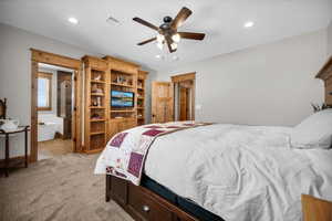 Bedroom with recessed lighting, light colored carpet, light tile patterned floors, a ceiling fan, and connected bathroom