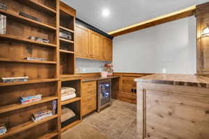 Kitchen with wine cooler, open shelves, tile patterned flooring, and recessed lighting