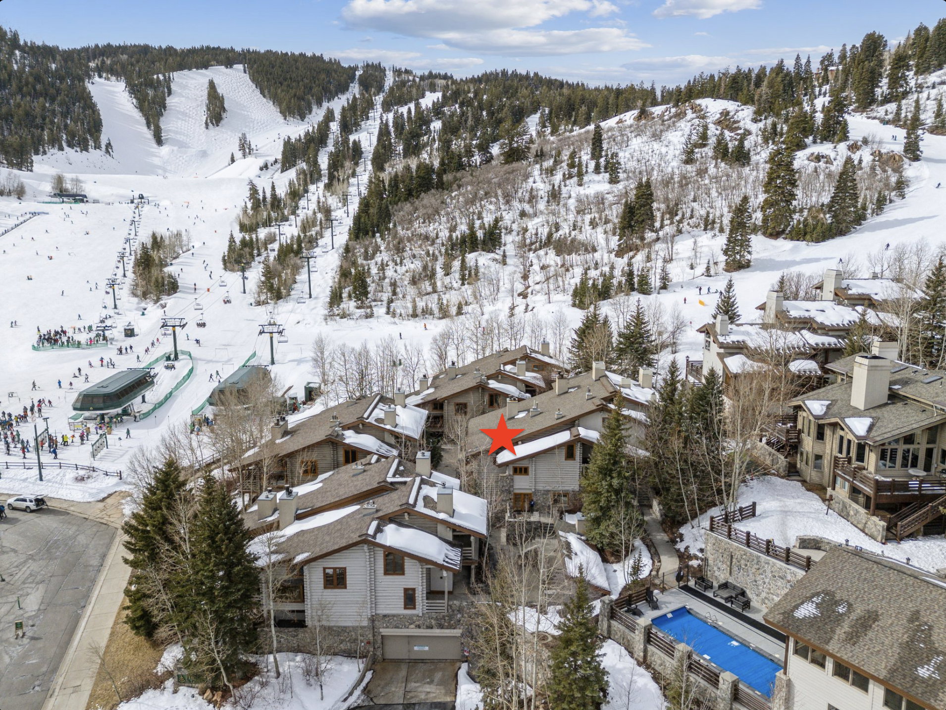 Snowy aerial view with a mountain view and a residential view