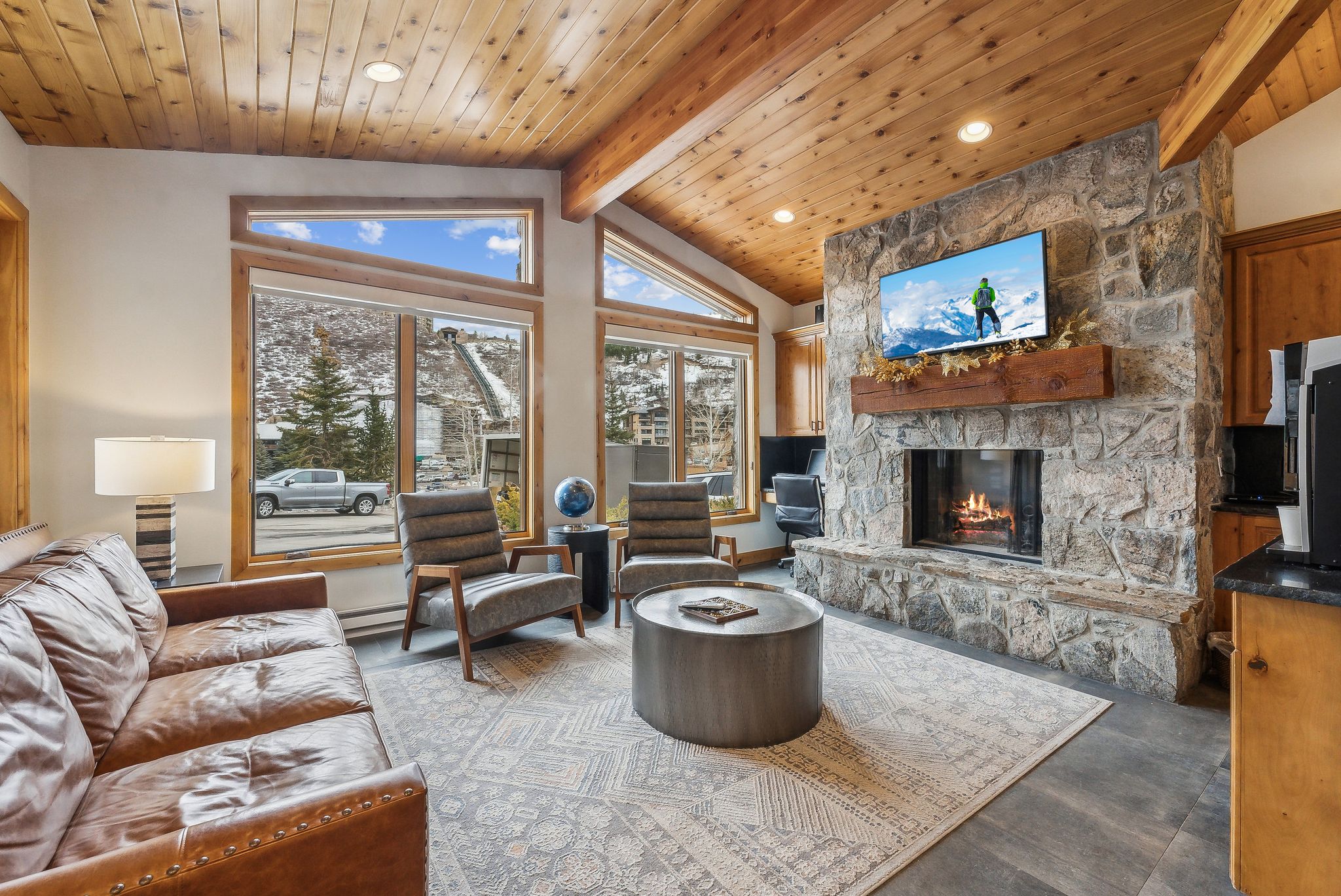 Living room featuring high vaulted ceiling, a fireplace, recessed lighting, wood ceiling, and beamed ceiling
