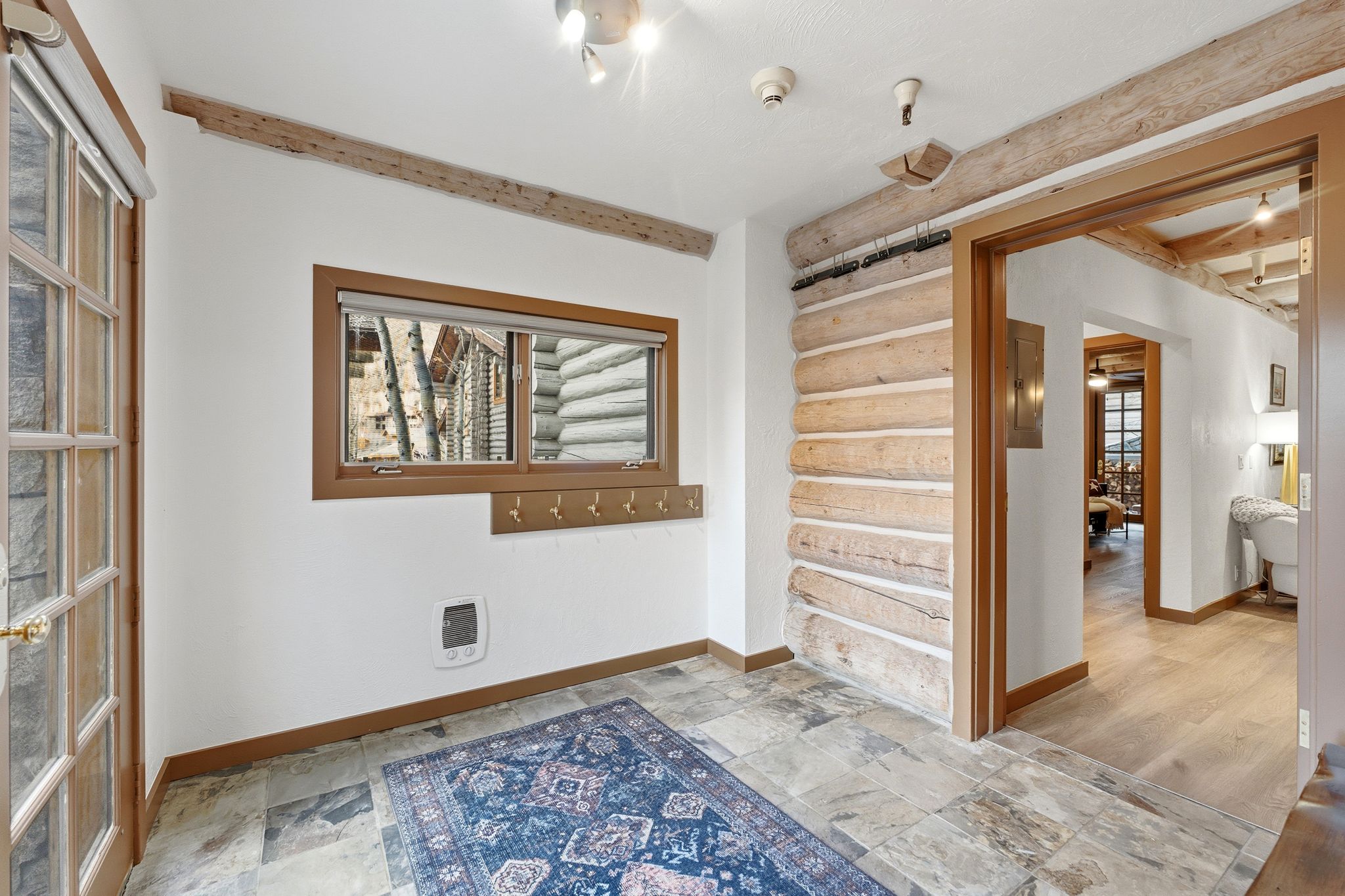 Unfurnished room with stone tile flooring and heating unit