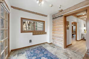 Unfurnished room with stone tile flooring and heating unit