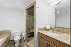 Bathroom featuring vanity and a shower stall