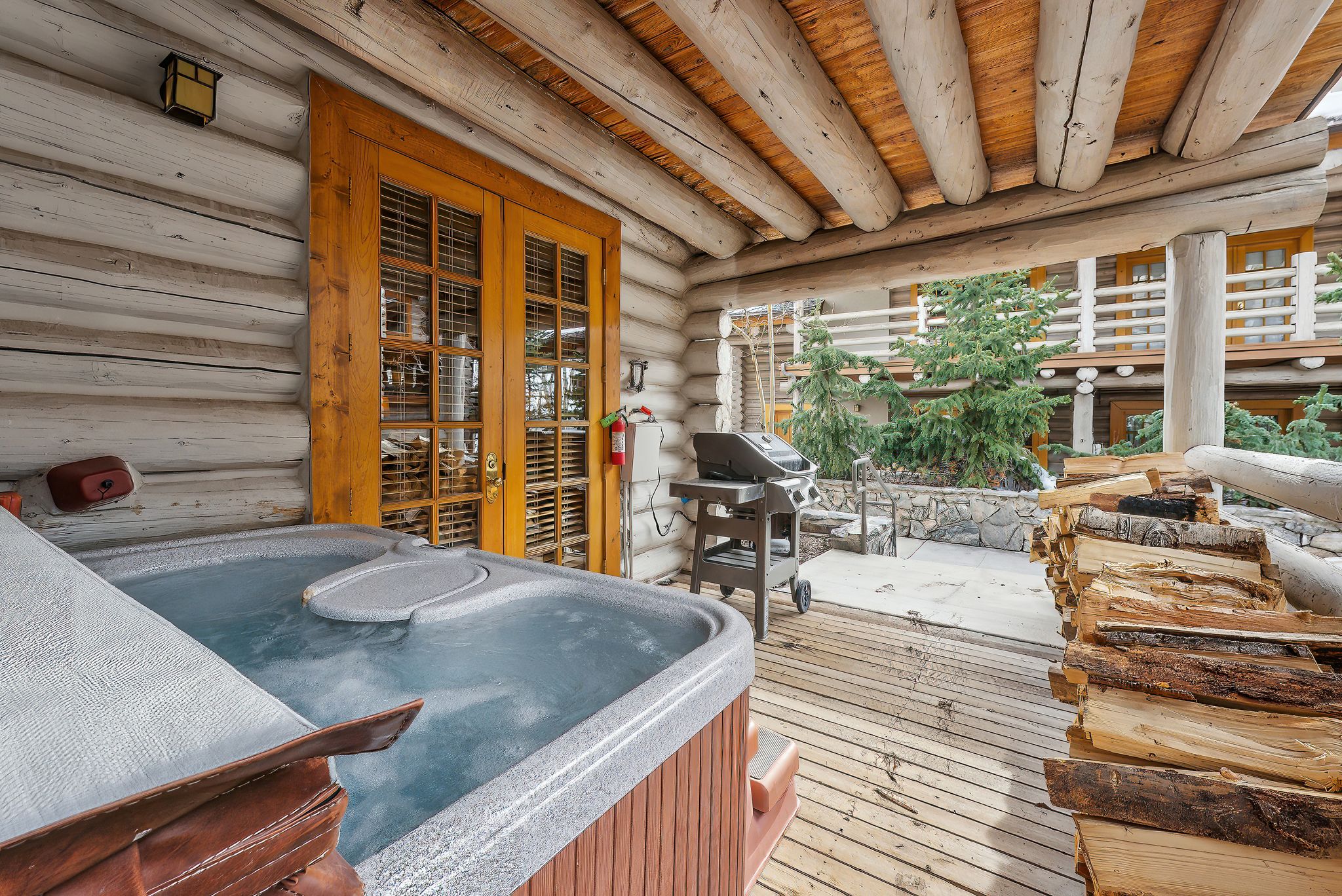 Deck featuring grilling area, french doors, and a hot tub